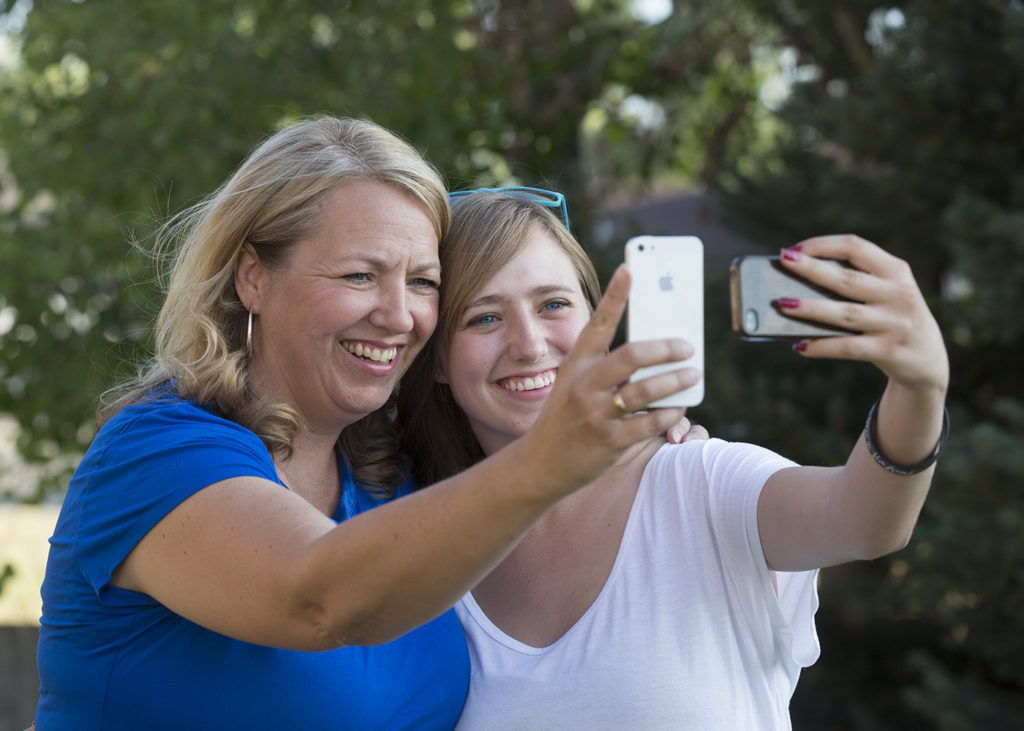 1307-07 75.JPG Syd and Brooke Jacques take photos of themselves on their smart phones. Sarah Coyne research that Teens feel closer to parents when they connect on social media. July 3, 2013 Photography by Mark A. Philbrick/BYU Copyright BYU Photo 2013 All Rights Reserved photo@byu.edu (801)422-7322